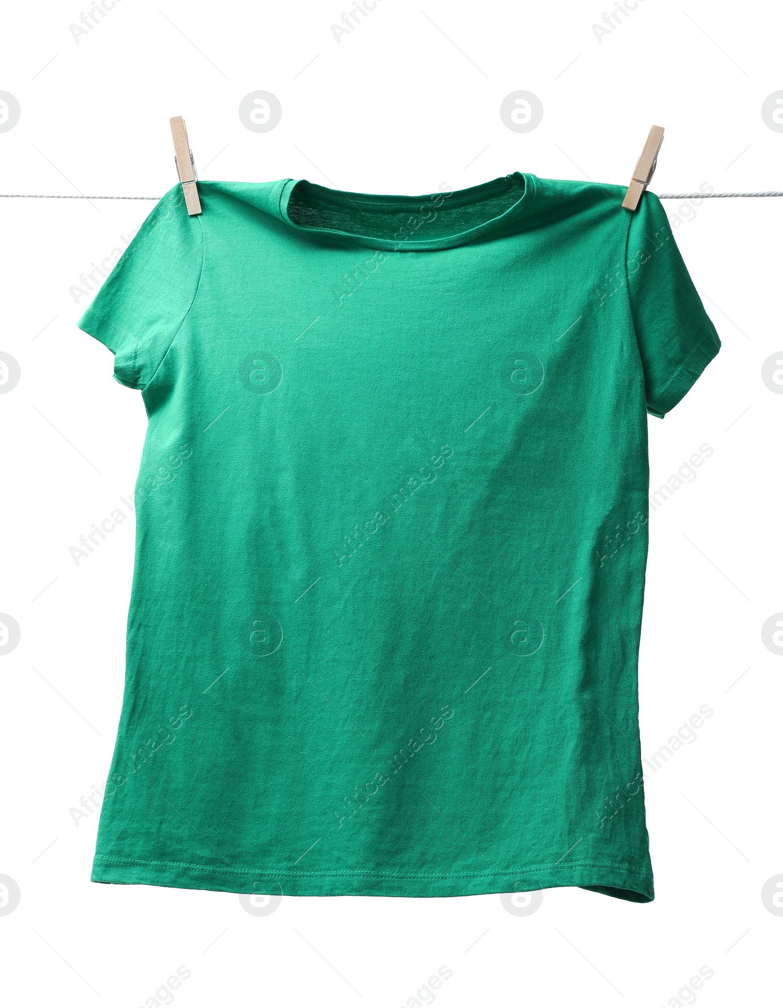 Photo of One green t-shirt drying on washing line isolated on white