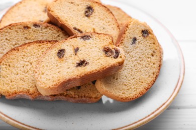 Plate of sweet hard chuck crackers with raisins on white wooden table