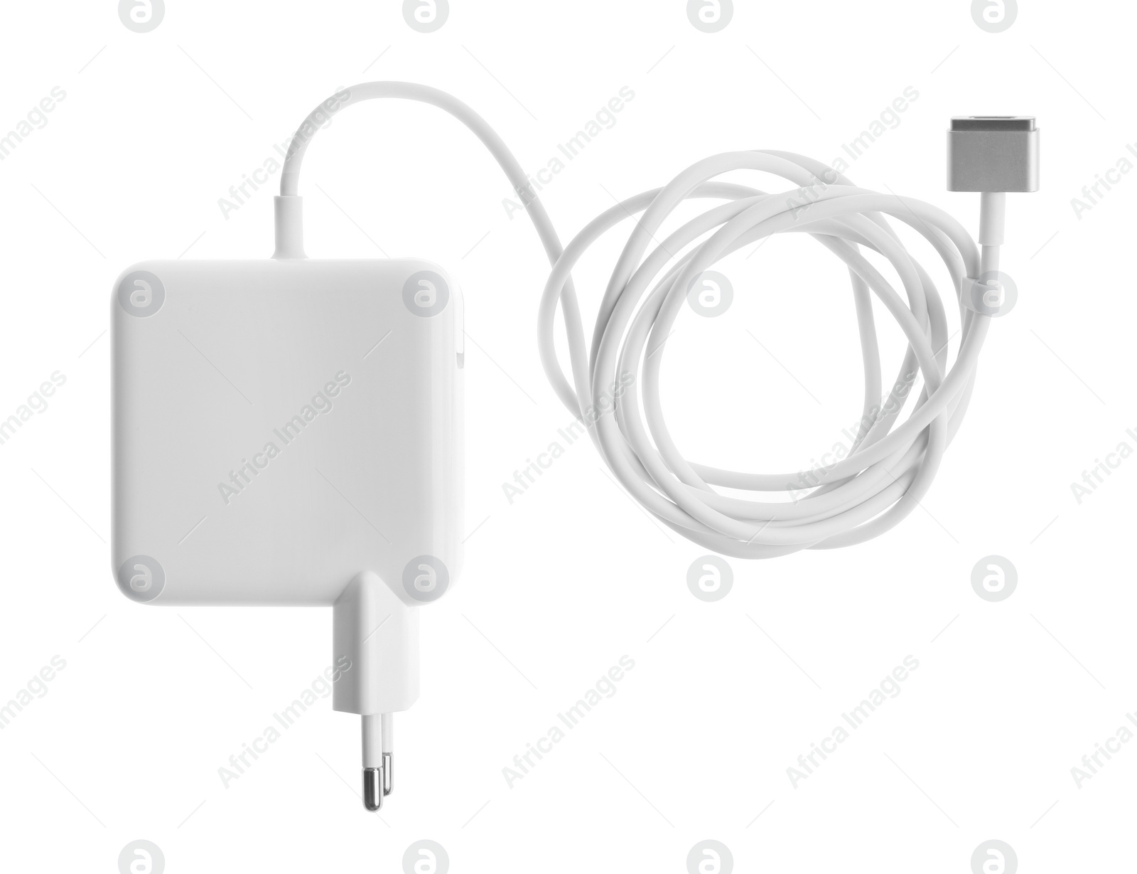 Photo of Laptop charger isolated on white, top view. Modern technology