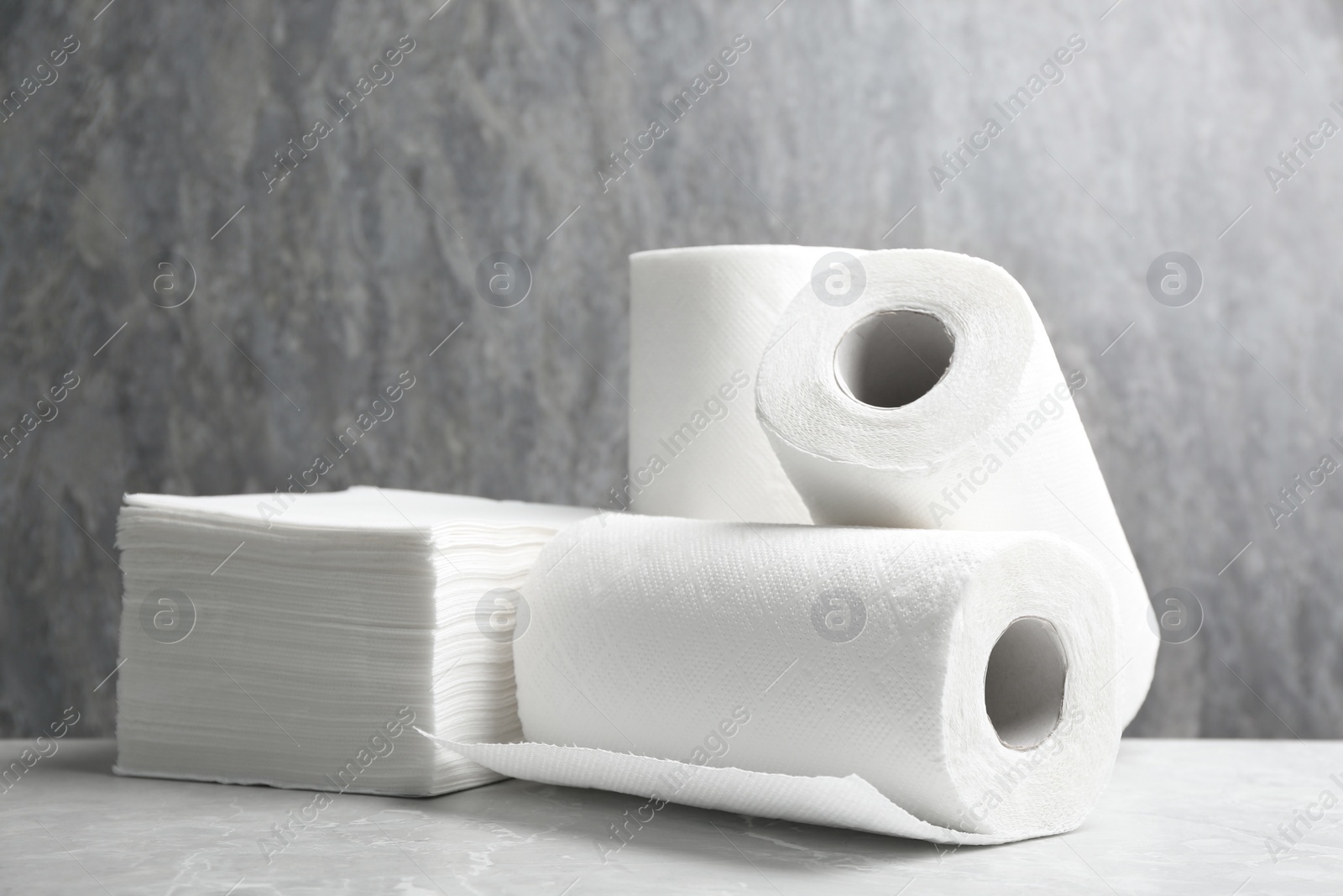 Photo of Rolls of paper towels and napkins on marble table