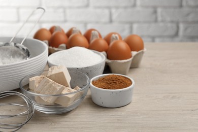 Photo of Flour, leaven and different ingredients on white wooden table, space for text. Cooking yeast cake