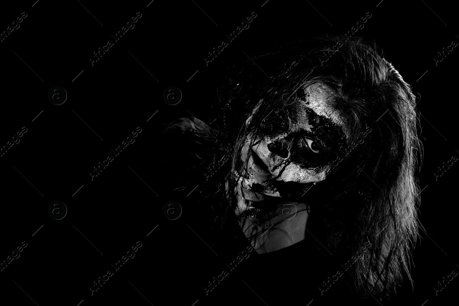 Photo of Scary zombie on dark background, black and white effect with space for text. Halloween monster