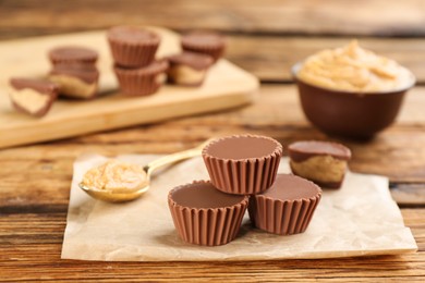 Delicious peanut butter cups on wooden table