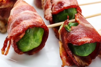 Plate with Brussels sprouts wrapped in bacon, closeup