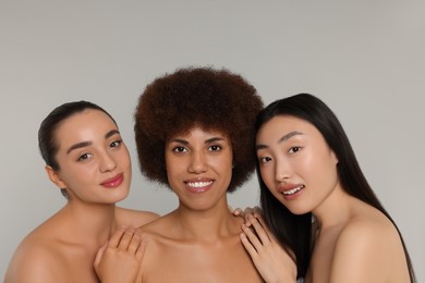 Portrait of beautiful young women on light grey background