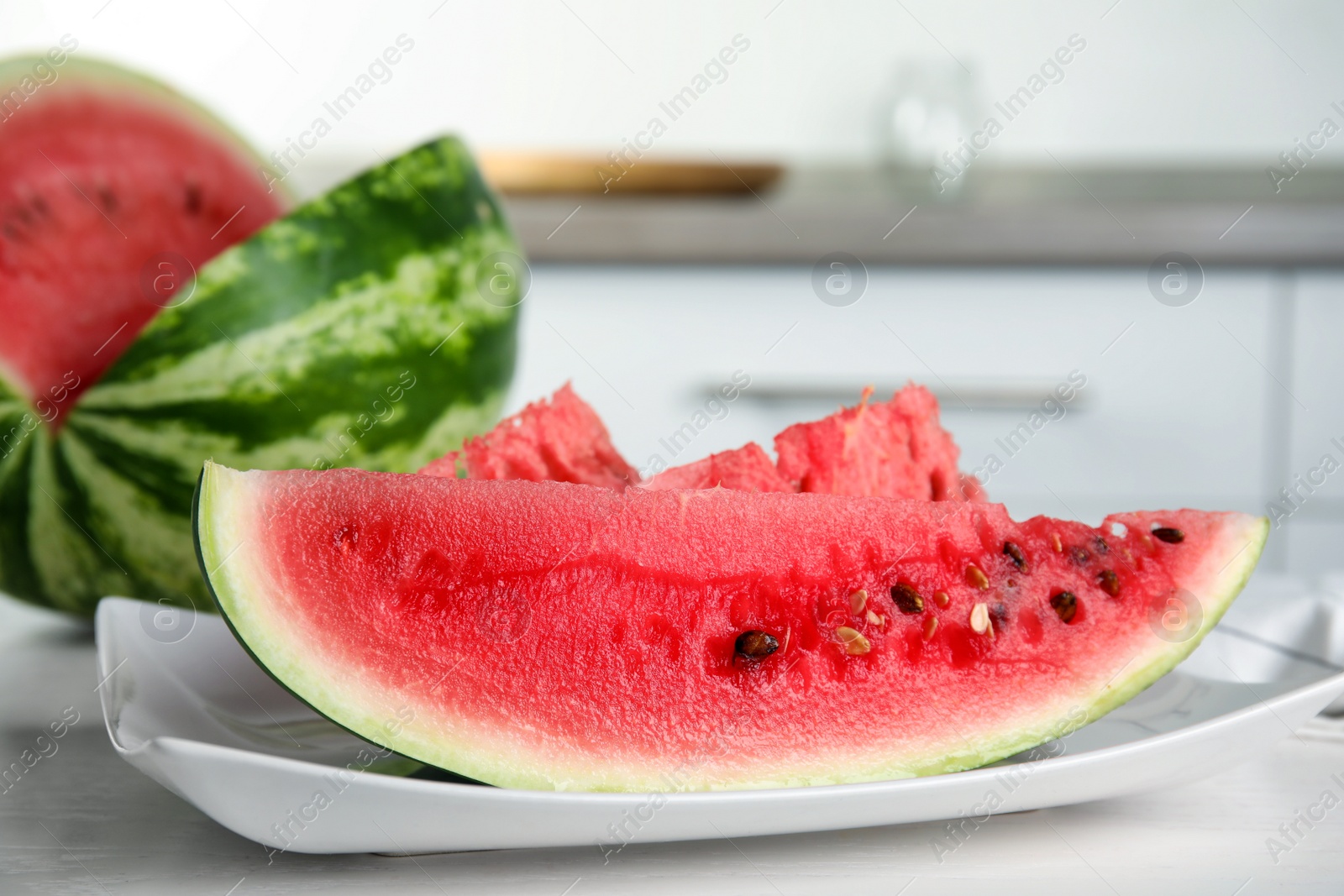 Photo of Yummy watermelon on white table in kitchen