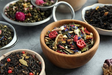 Photo of Many different herbal teas on grey table