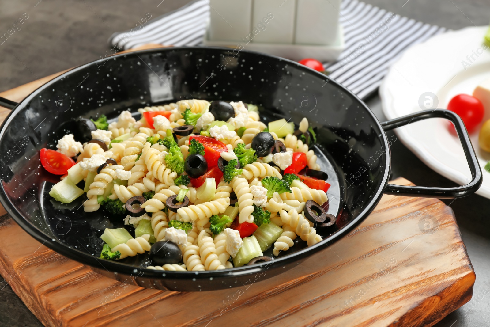 Photo of Tasty pasta with vegetables and  cheese in dish