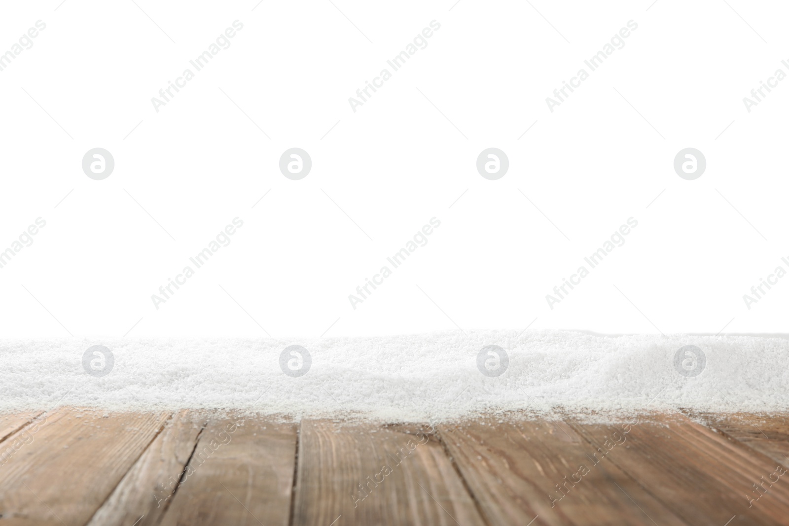 Photo of Artificial snow on wooden table against white background. Christmas decor