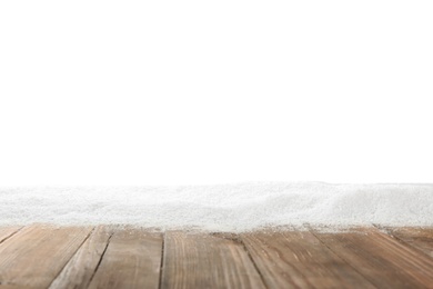 Photo of Artificial snow on wooden table against white background. Christmas decor