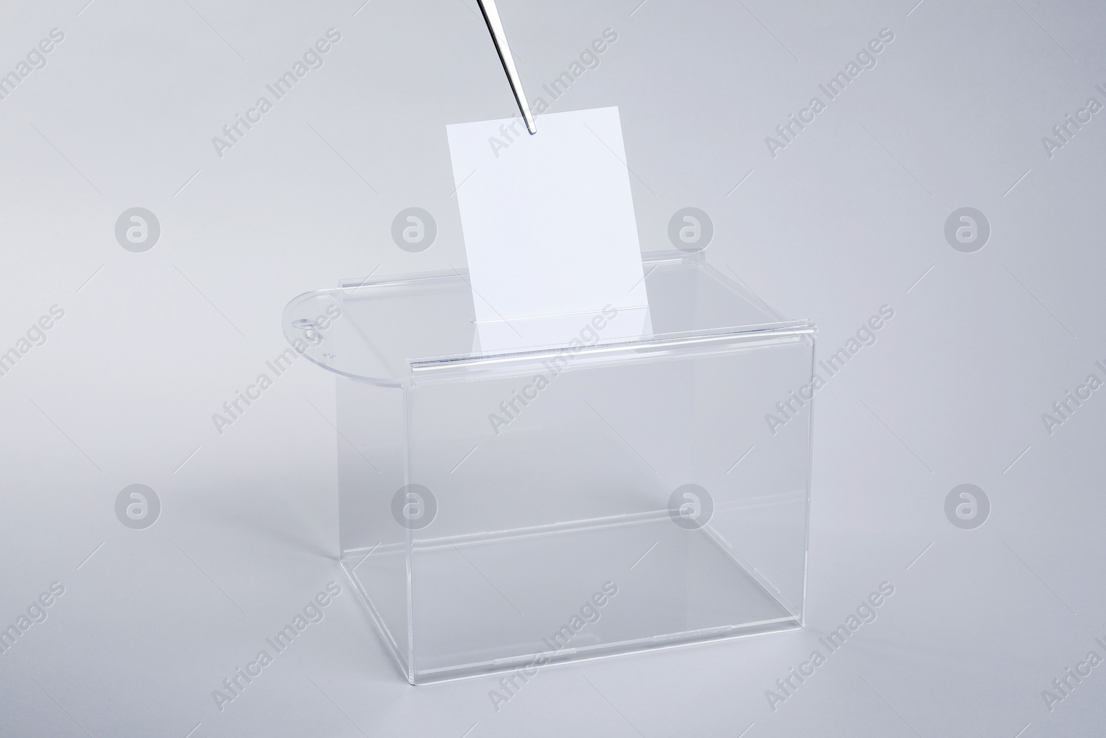 Photo of Ballot box with vote on light grey background. Election time