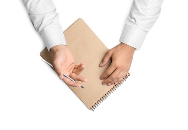 Photo of Man with pencil and notepad on white background, top view. Closeup of hands