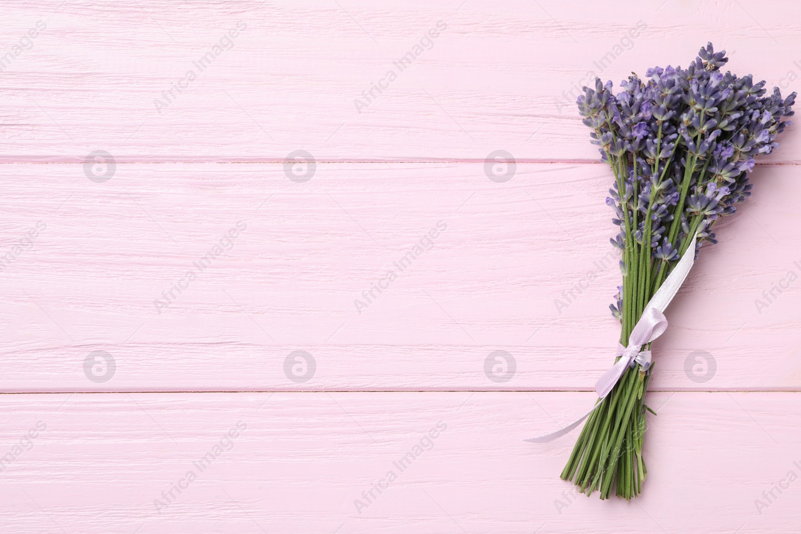 Photo of Beautiful lavender bouquet on pink wooden background, top view. Space for text