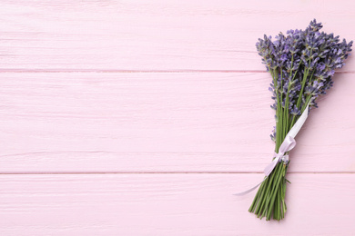 Beautiful lavender bouquet on pink wooden background, top view. Space for text