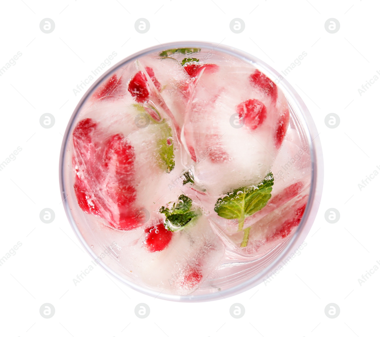 Photo of Glass of drink with pomegranate ice cubes on white background, top view