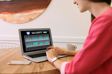 Woman using home security app indoors, closeup