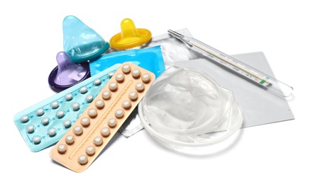 Contraceptive pills, condoms, patch and thermometer isolated on white. Different birth control methods