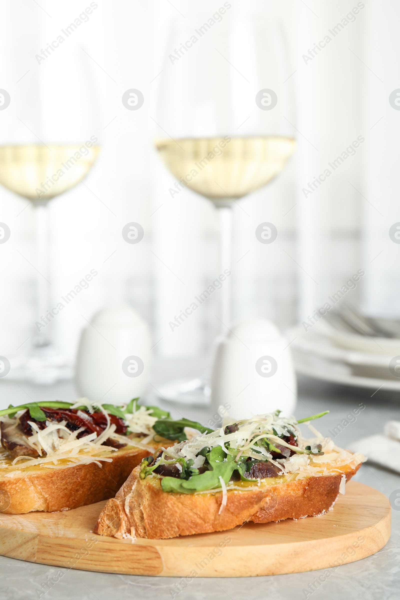 Photo of Delicious bruschettas with beef and cheese on marble table