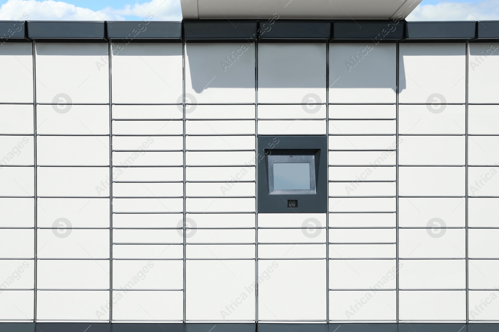 Photo of Modern parcel locker with many postal boxes outdoors