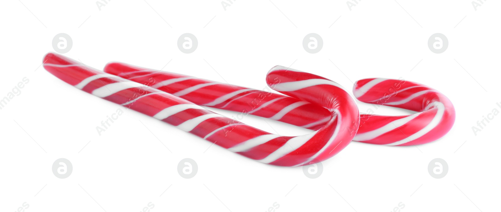 Photo of Sweet Christmas candy canes on white background