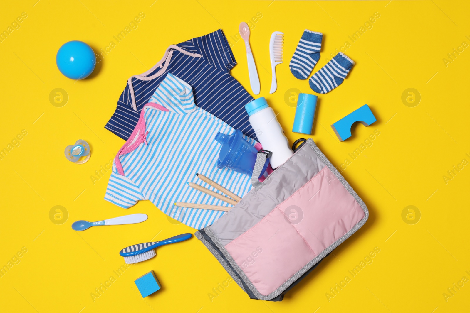 Photo of Flat lay composition with baby accessories and maternity bag on color background
