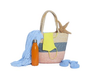 Photo of Beach bag, thermo bottle, clothes, starfish and flip flops isolated on white