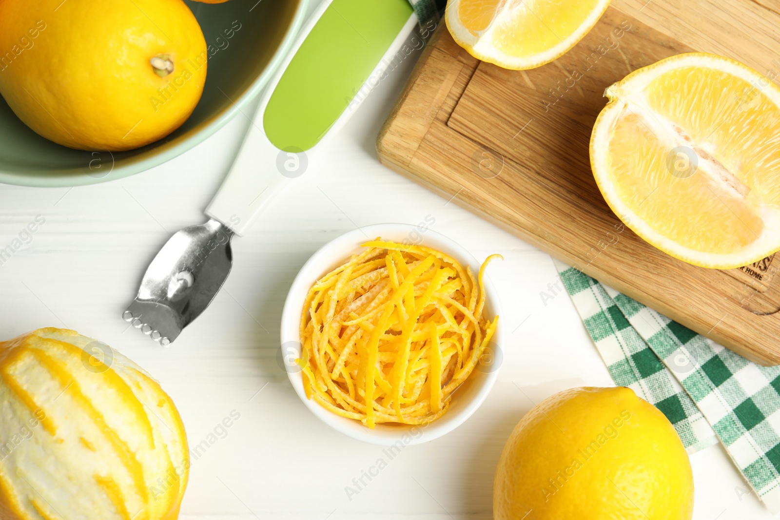 Photo of Lemon zest and fresh fruits on white wooden table, flat lay