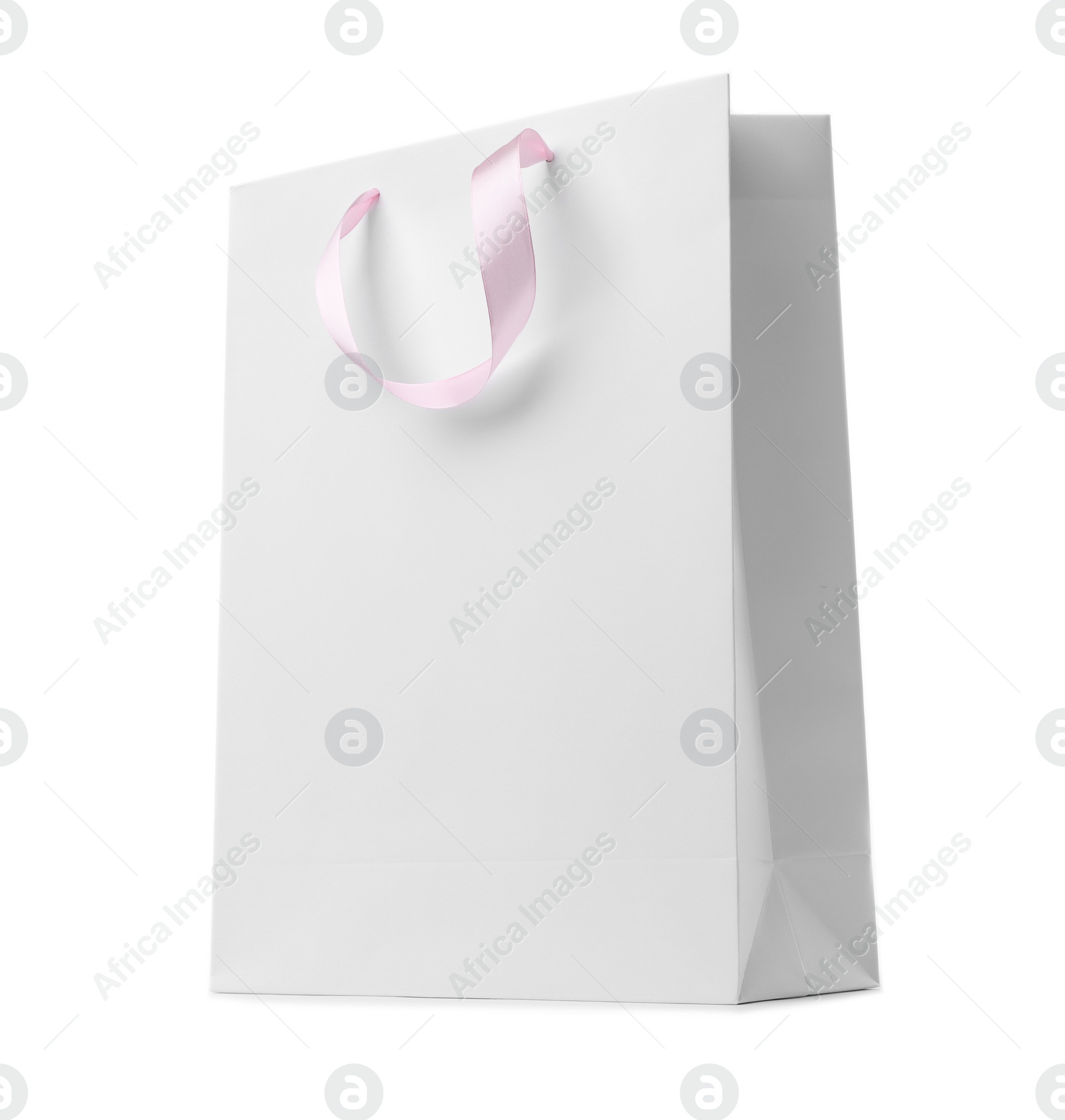 Photo of Paper shopping bag with ribbon handles on white background. Mockup for design