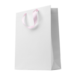 Photo of Paper shopping bag with ribbon handles on white background. Mockup for design