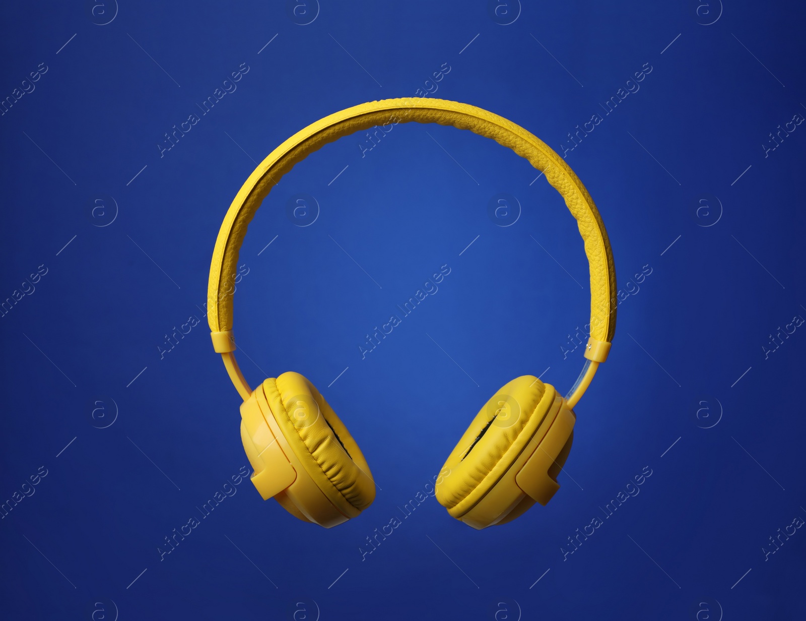 Photo of Stylish modern headphones with earmuffs on color background