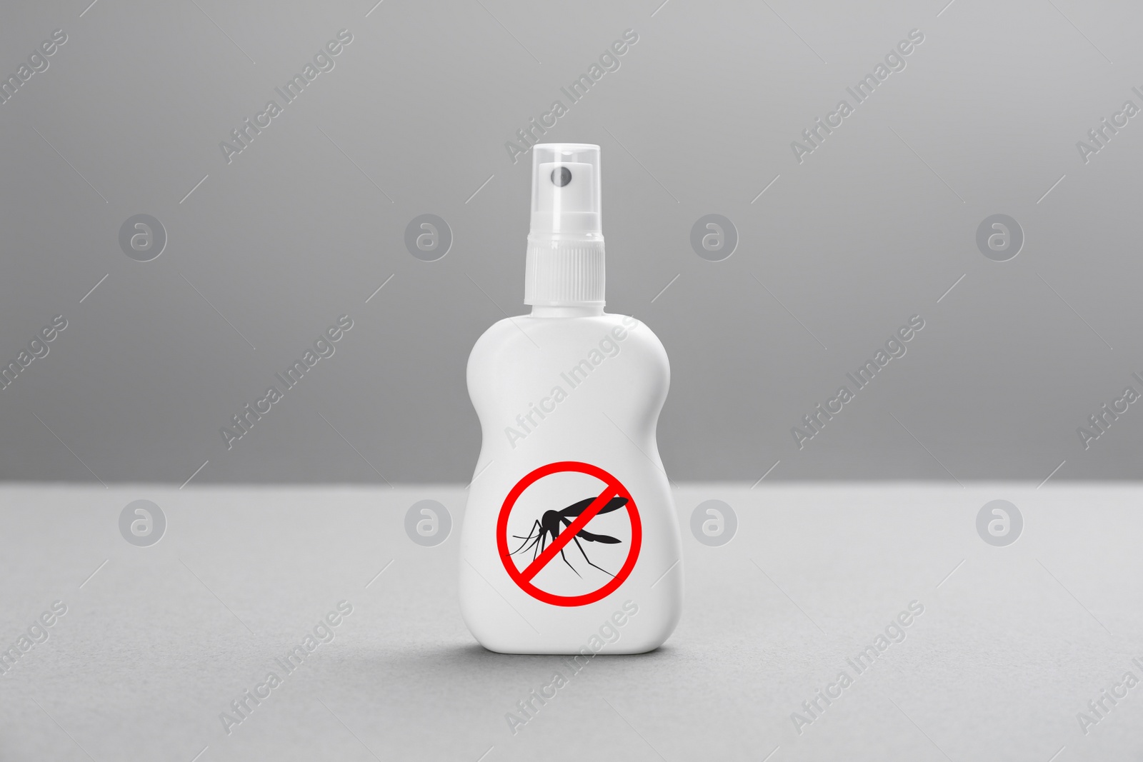 Image of Bottle of insect repellent on grey background