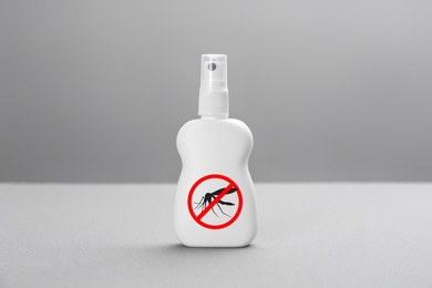 Image of Bottle of insect repellent on grey background