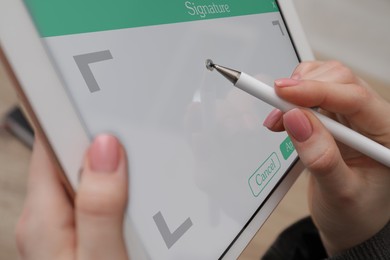 Image of Electronic signature. Woman using stylus and tablet, closeup