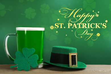 Green beer, hat and clover on wooden table. St. Patrick's Day celebration