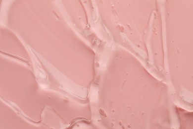 Sample of clear cosmetic gel on pink background, top view