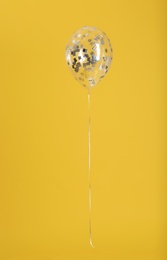 Photo of Balloon with sparkles on color background. Space for text