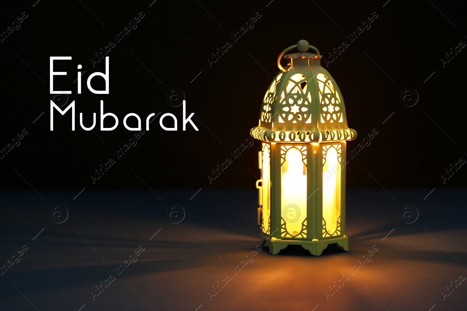 Image of Eid Mubarak greeting card. Arabic lantern on dark background