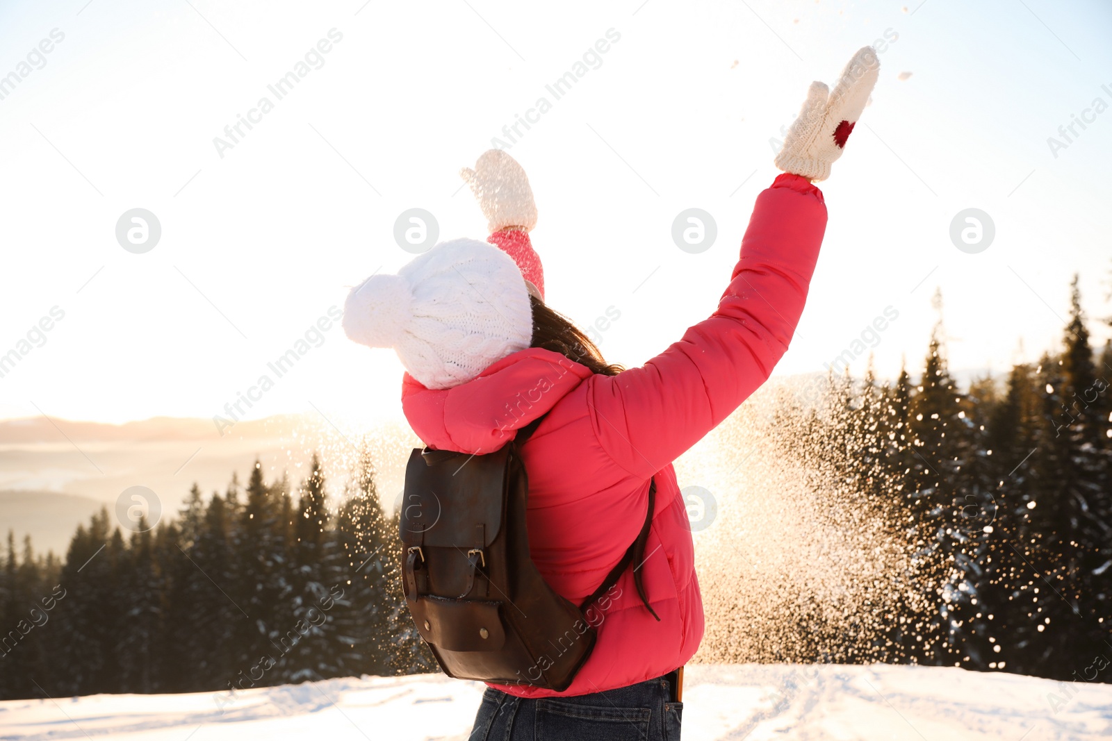 Photo of Young woman having fun outdoors on snowy winter day