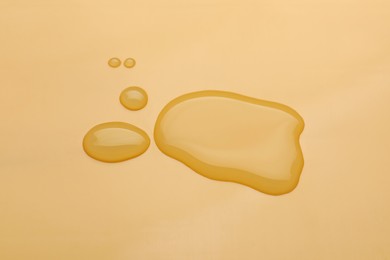 Puddle of water on pale orange background