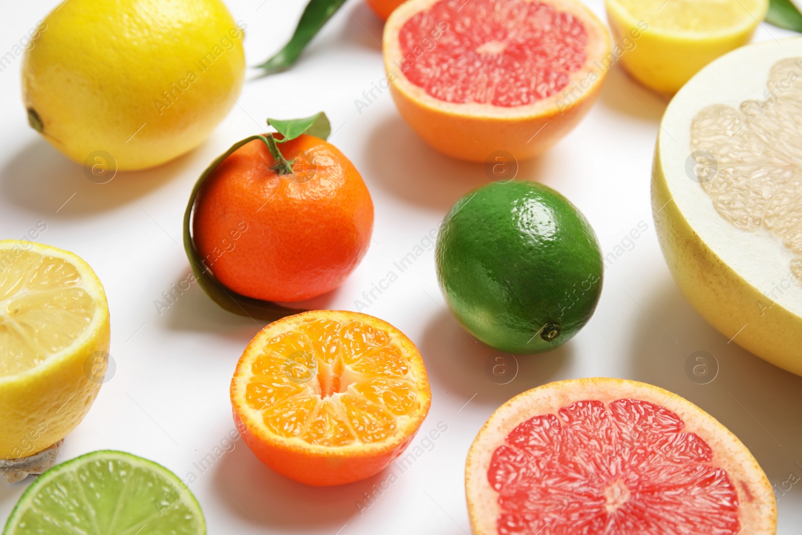 Photo of Different juicy citrus fruits on white background