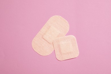 Photo of Contraceptive patches on pink background, top view