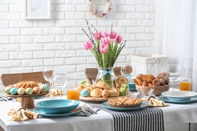 Photo of Festive Easter table setting with traditional meal at home