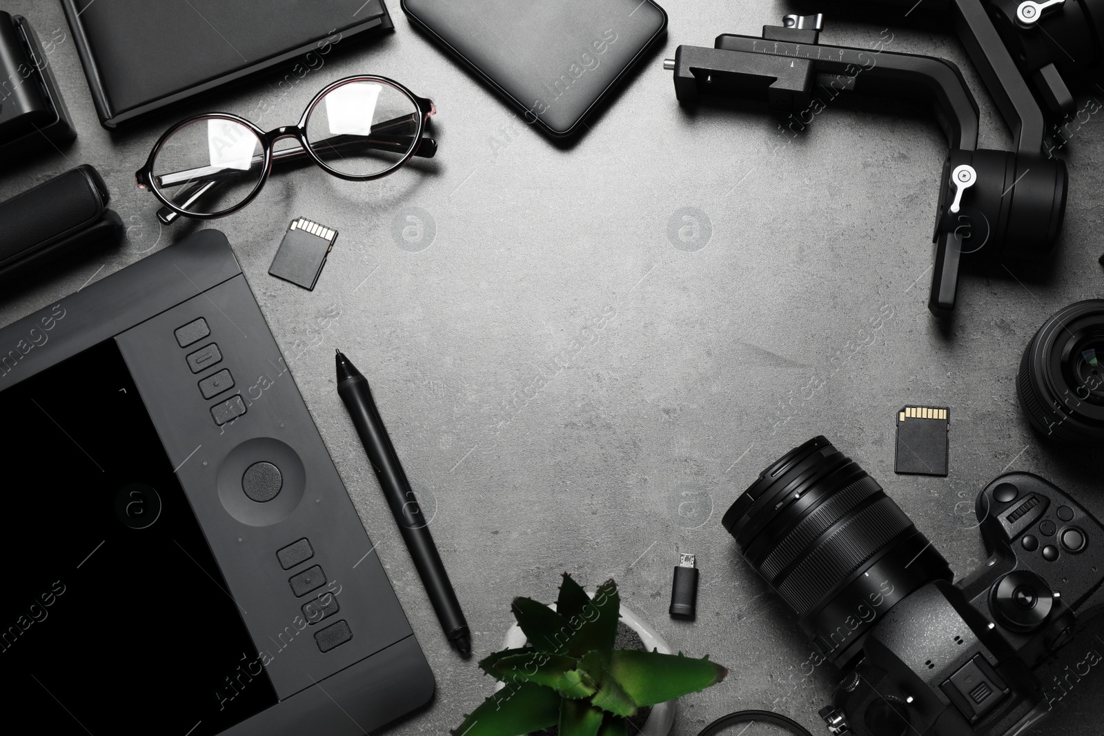 Photo of Camera and video production equipment on grey stone background, flat lay. Space for text
