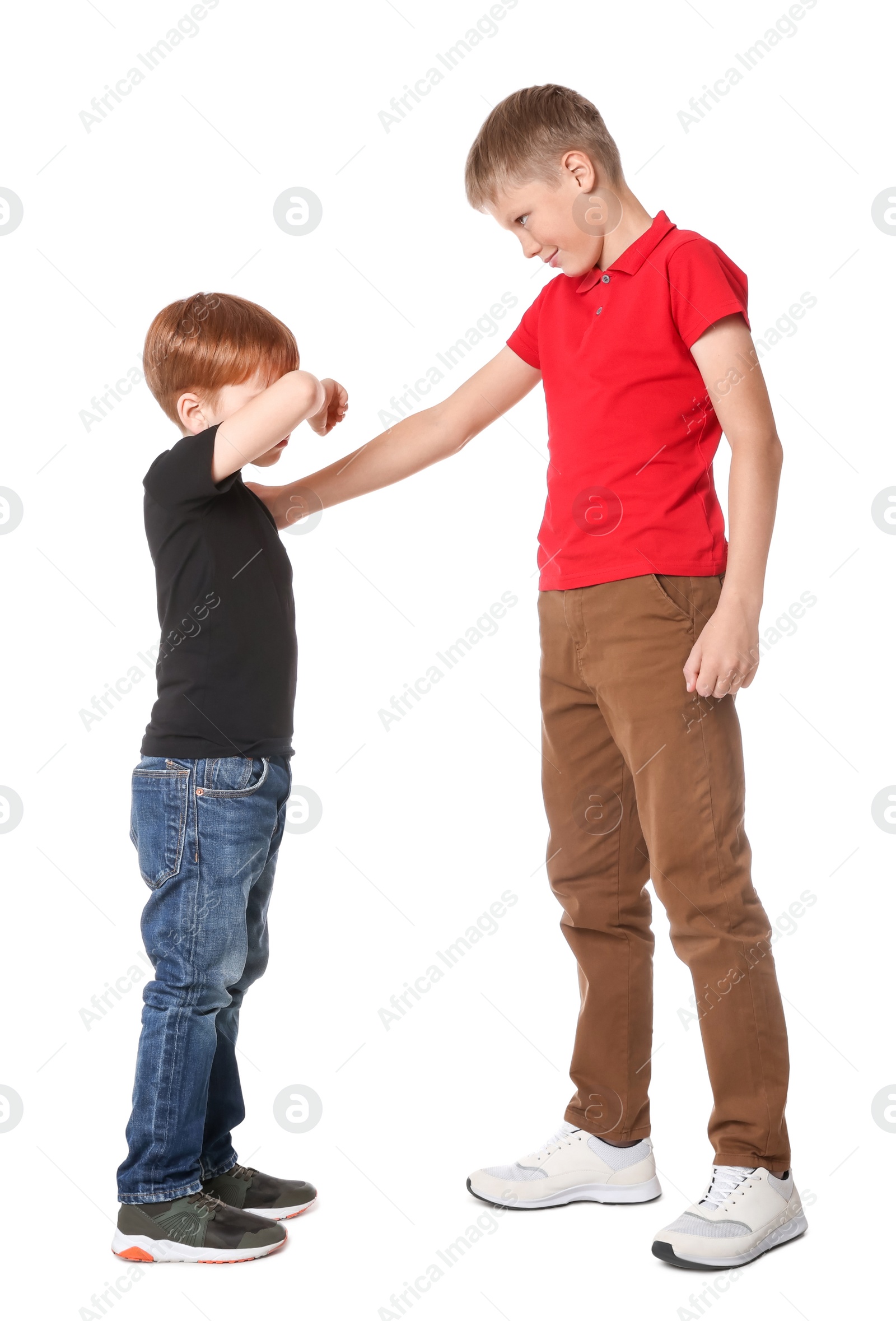 Photo of Boy bullying upset kid on white background