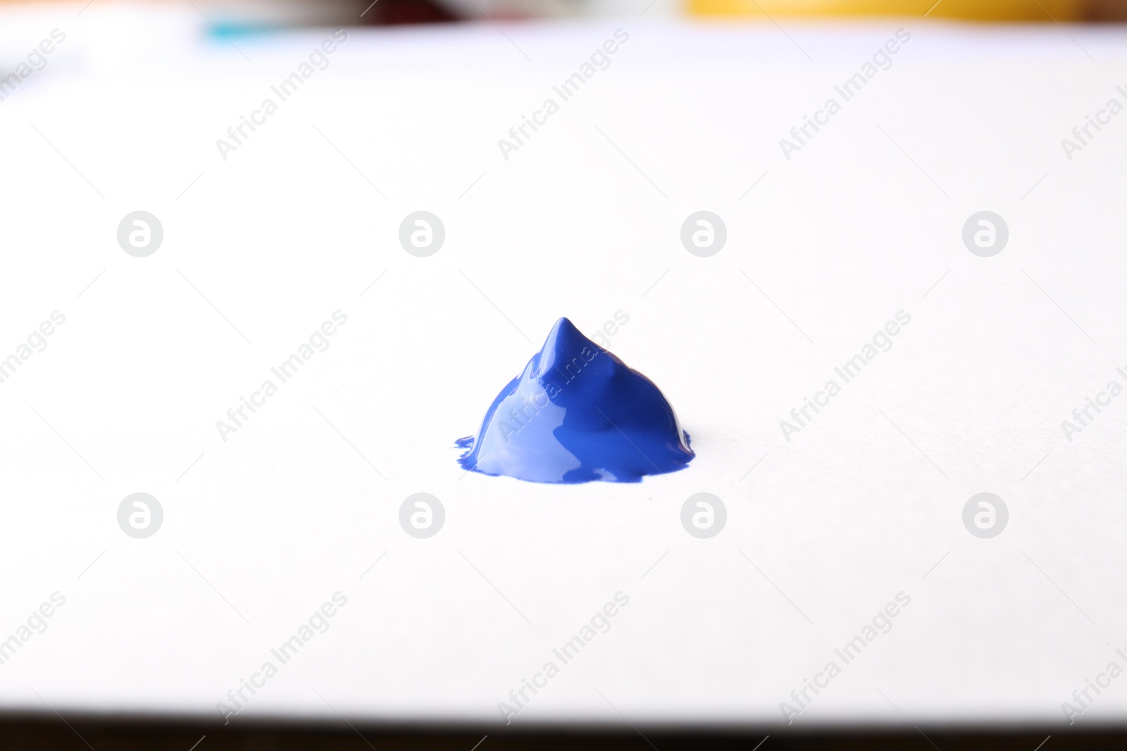 Photo of Sample of blue paint on white background