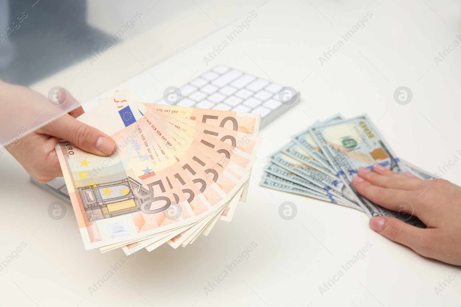 Photo of Woman exchanging money at cash department window, closeup