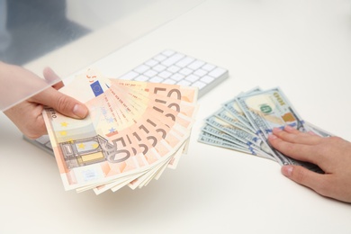 Photo of Woman exchanging money at cash department window, closeup