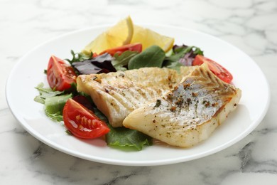 Photo of Tasty cod cooked served with salad on white marble table