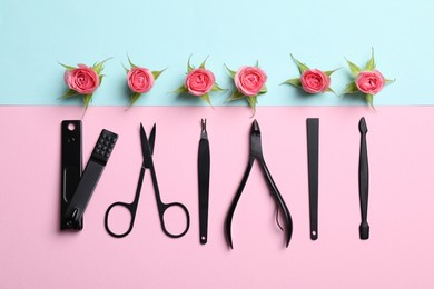 Photo of Manicure tools and roses on color background, flat lay