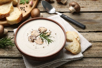 Photo of Fresh homemade mushroom soup served on wooden table